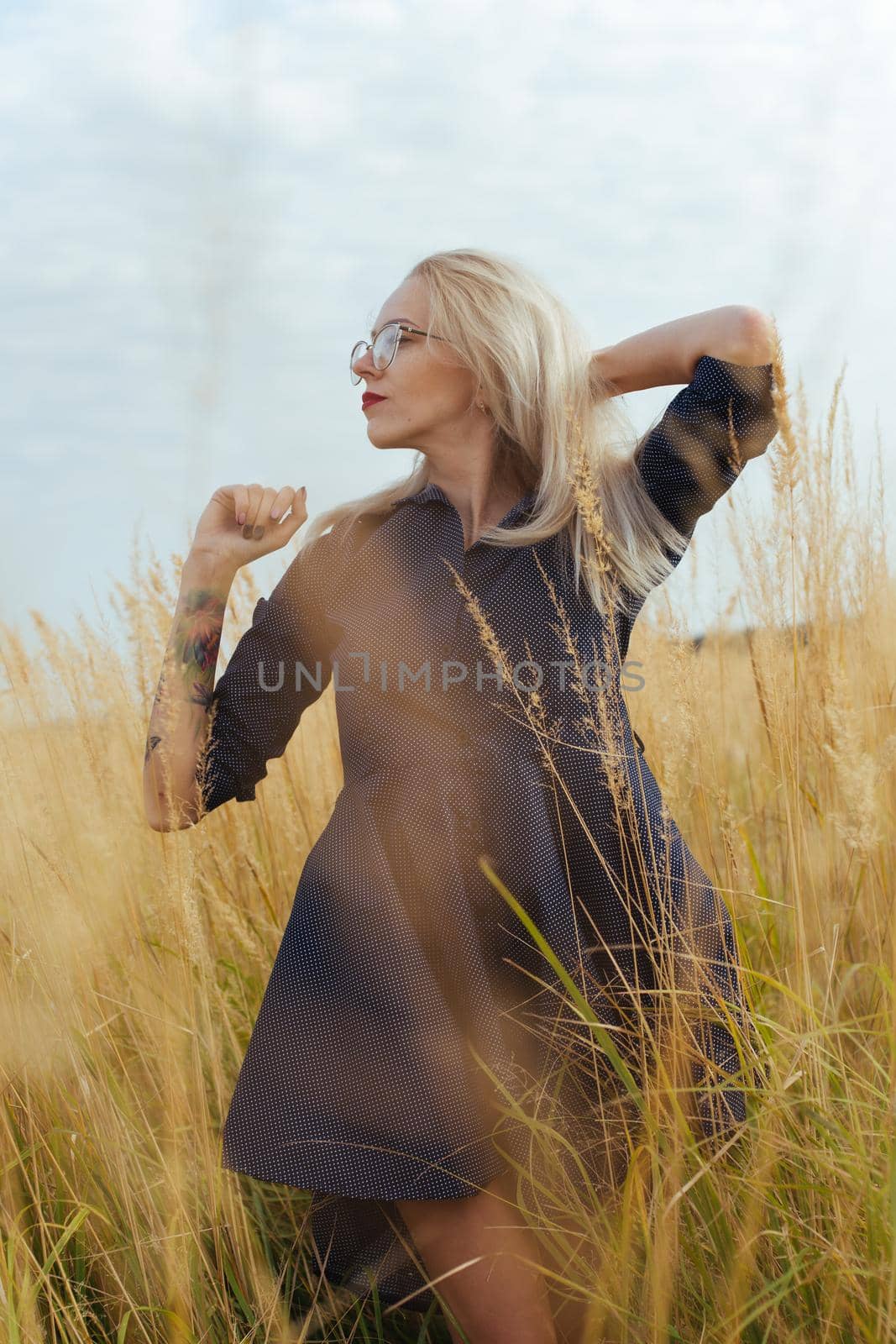 Beautiful girl villager posing in a dress in the field