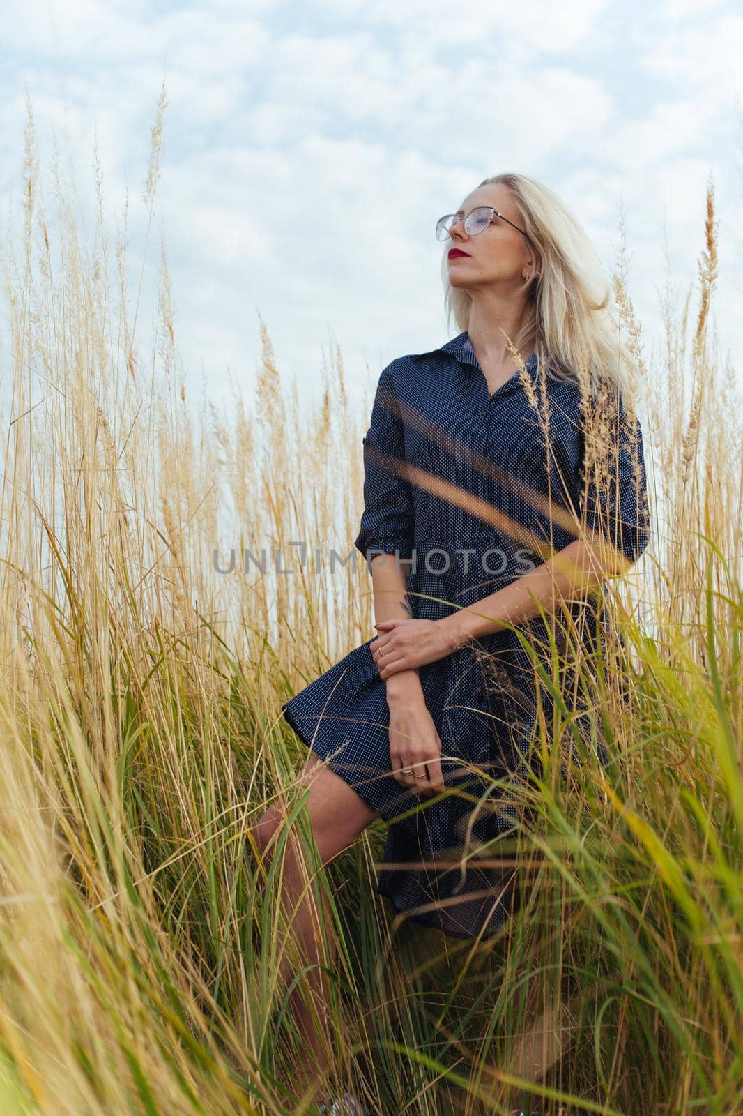 Beautiful girl villager posing in a dress in the field