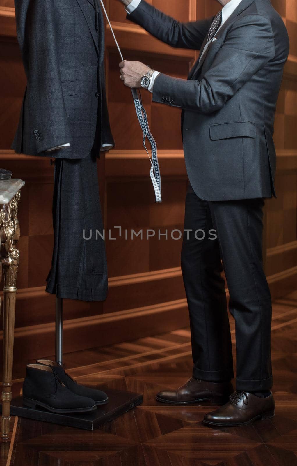 Tailor measuring suit on dummy by Demkat