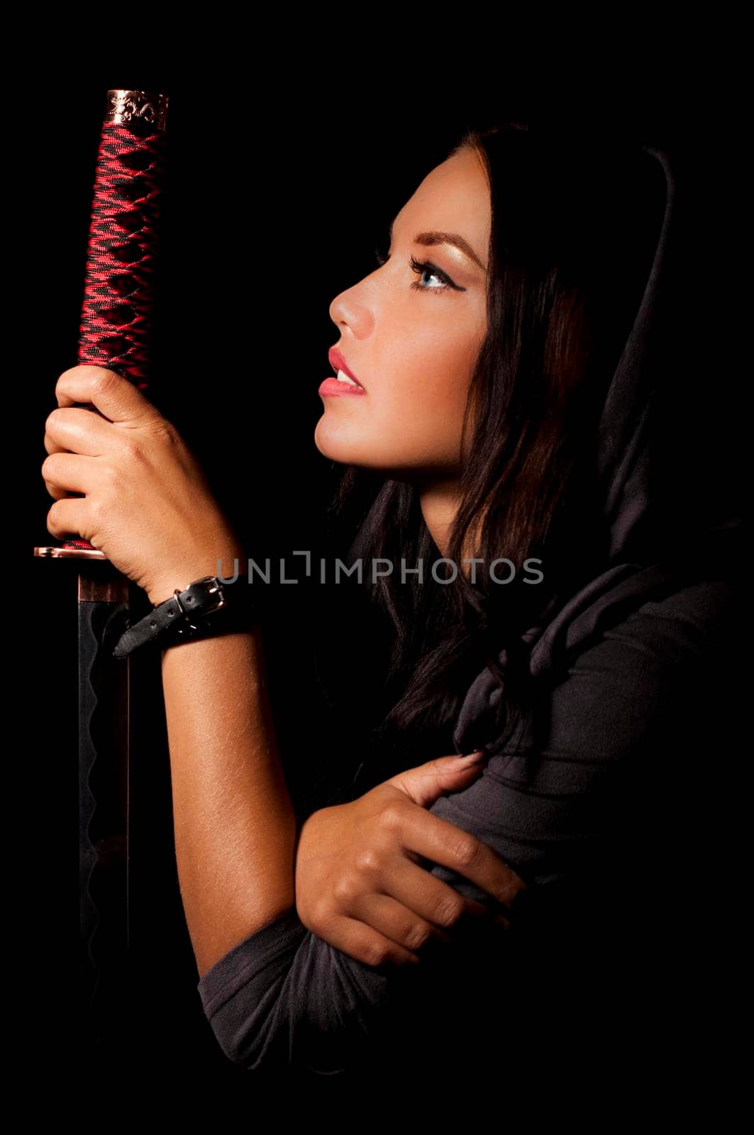 young woman in japanese anime cosplay, holding samurai sword.