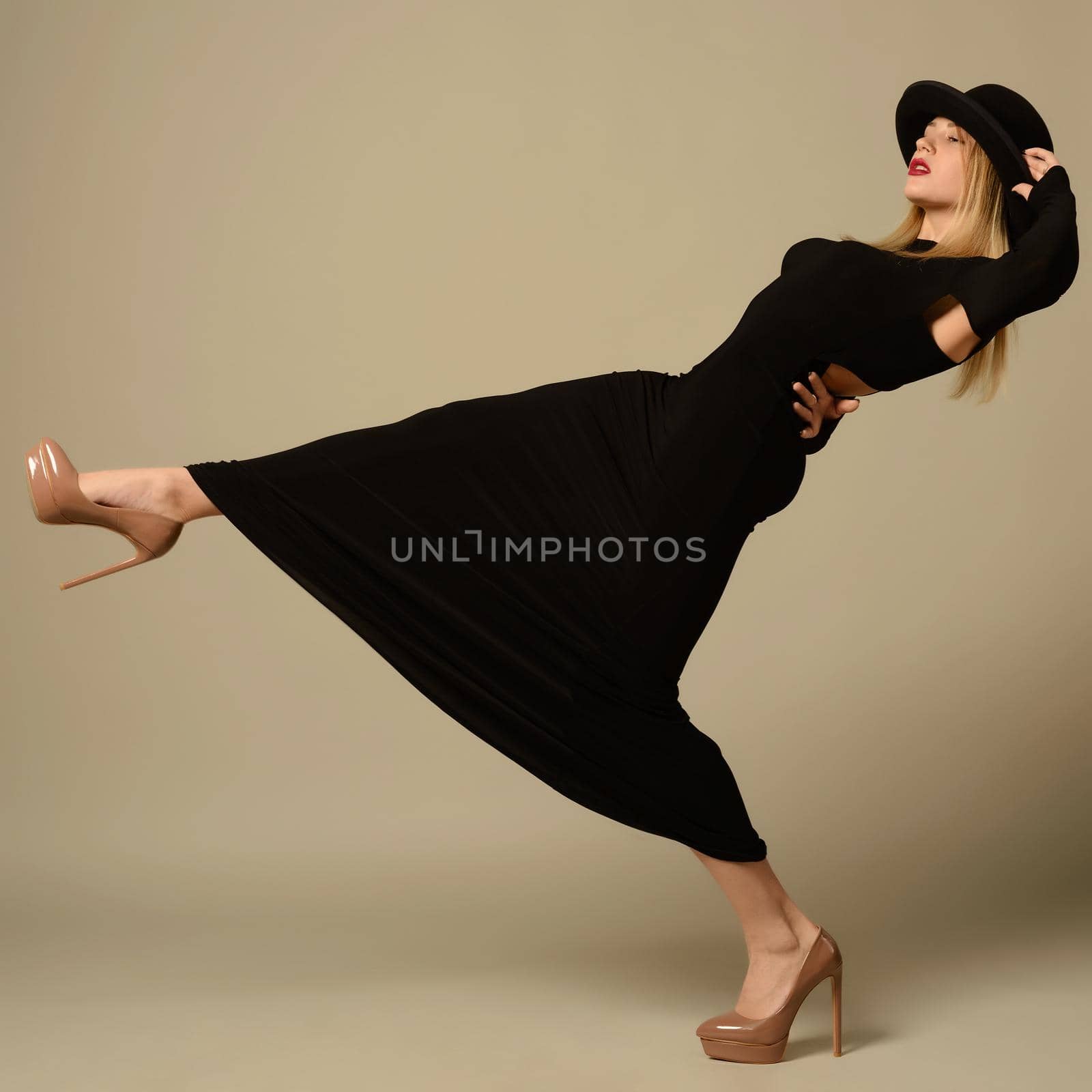 young girl in black evening dress and hat slipped on her back.