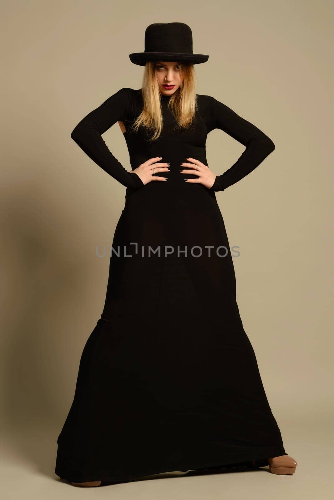 Fashion photo of beautiful lady in elegant black dress and hat