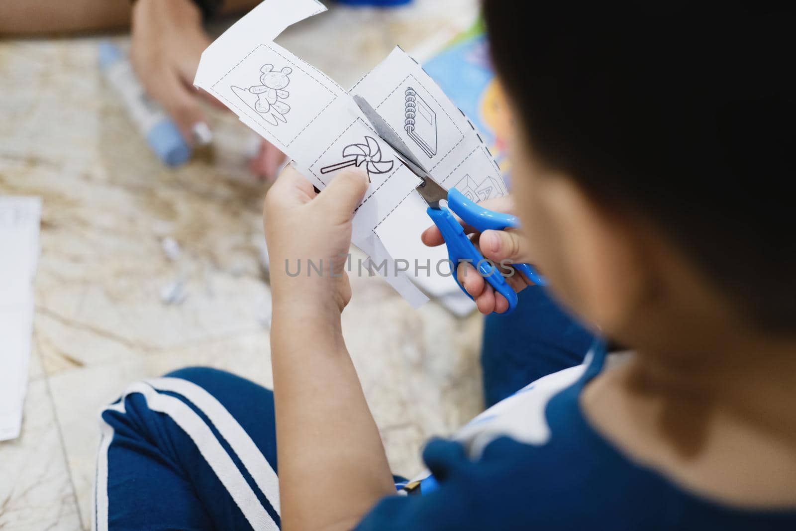 Childhood are learning to use scissors to cut paper