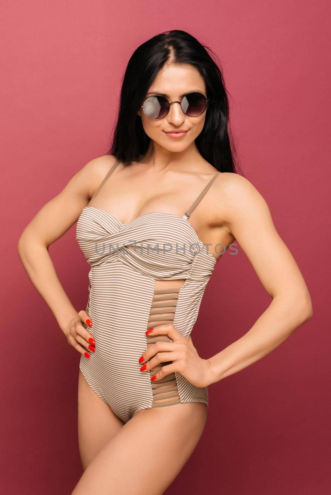 Cute smile girl in striped swimsuit and black sunglasses with by zartarn