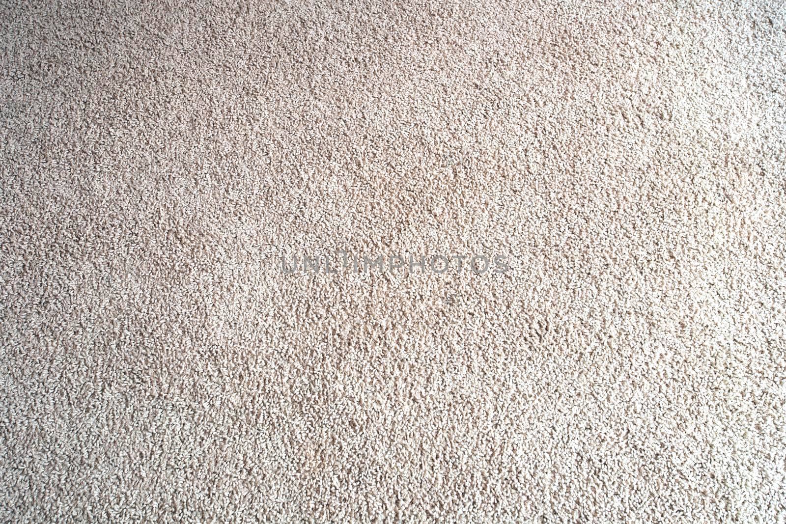 Bright beige wool fabric carpet or rug background texture close-up new and clean