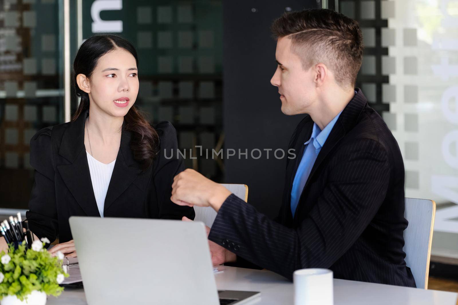 A female advisor is recommending a way to market male business owners to restructure their investments. by Manastrong
