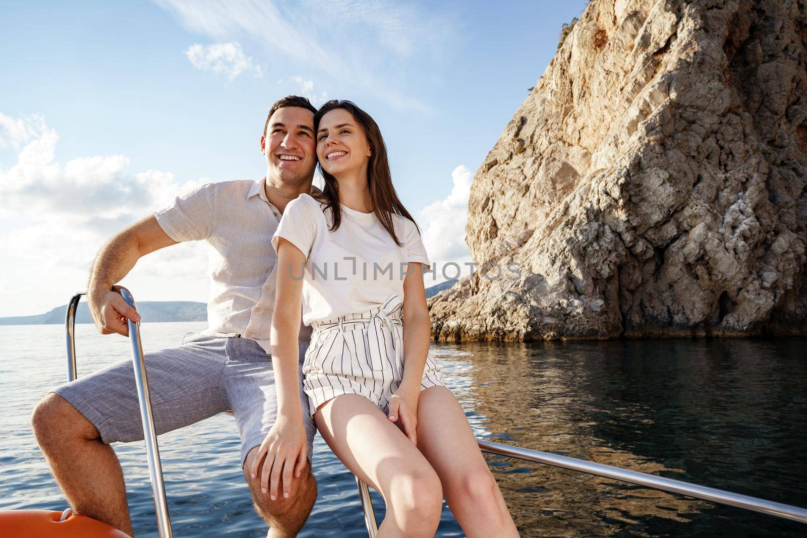 Happy couple in love on a yacht in summer on romantic vacation