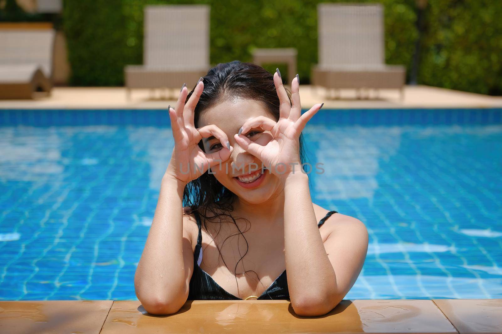 Beautiful southeast asia woman in pool relaxing