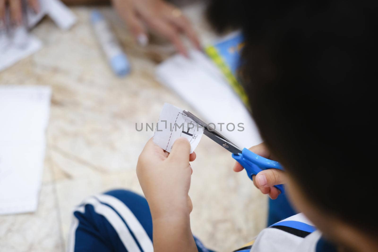 Childhood are learning to use scissors to cut paper