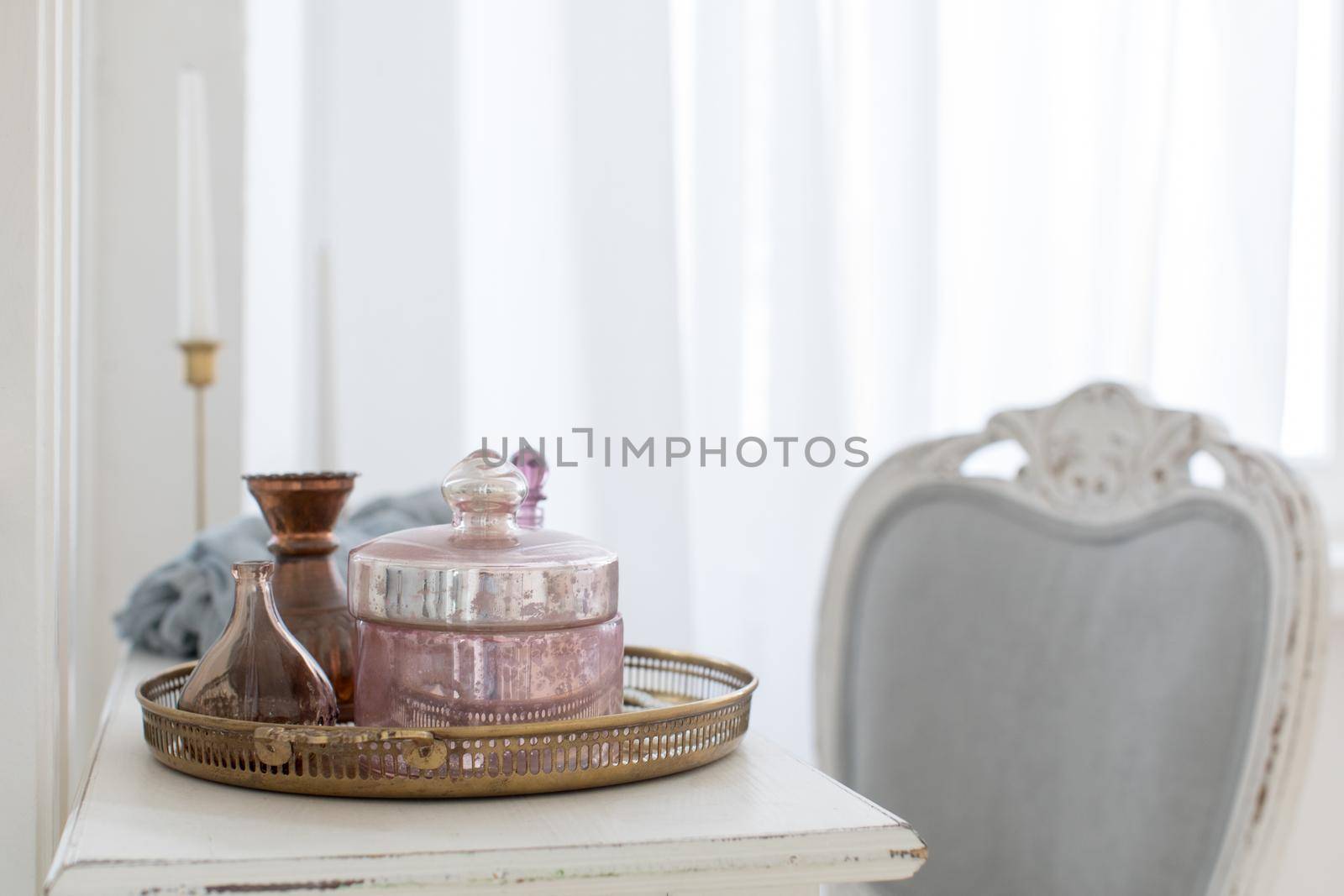 Still life in a boudoir on a ladies table. Interior with wooden table and different cosmetics at home.
