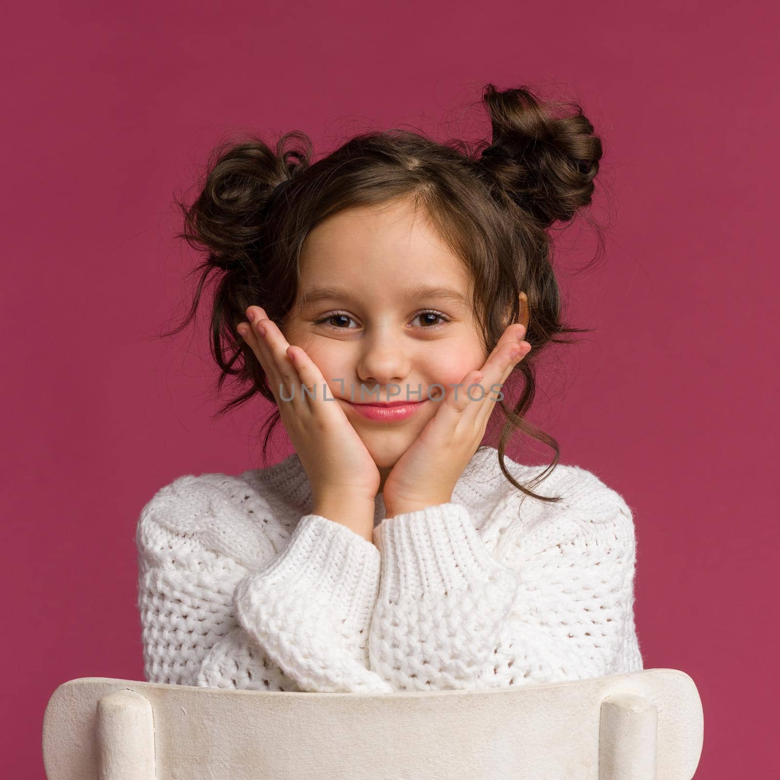 Photo of smiling little girl child isolated over pink background. by zartarn
