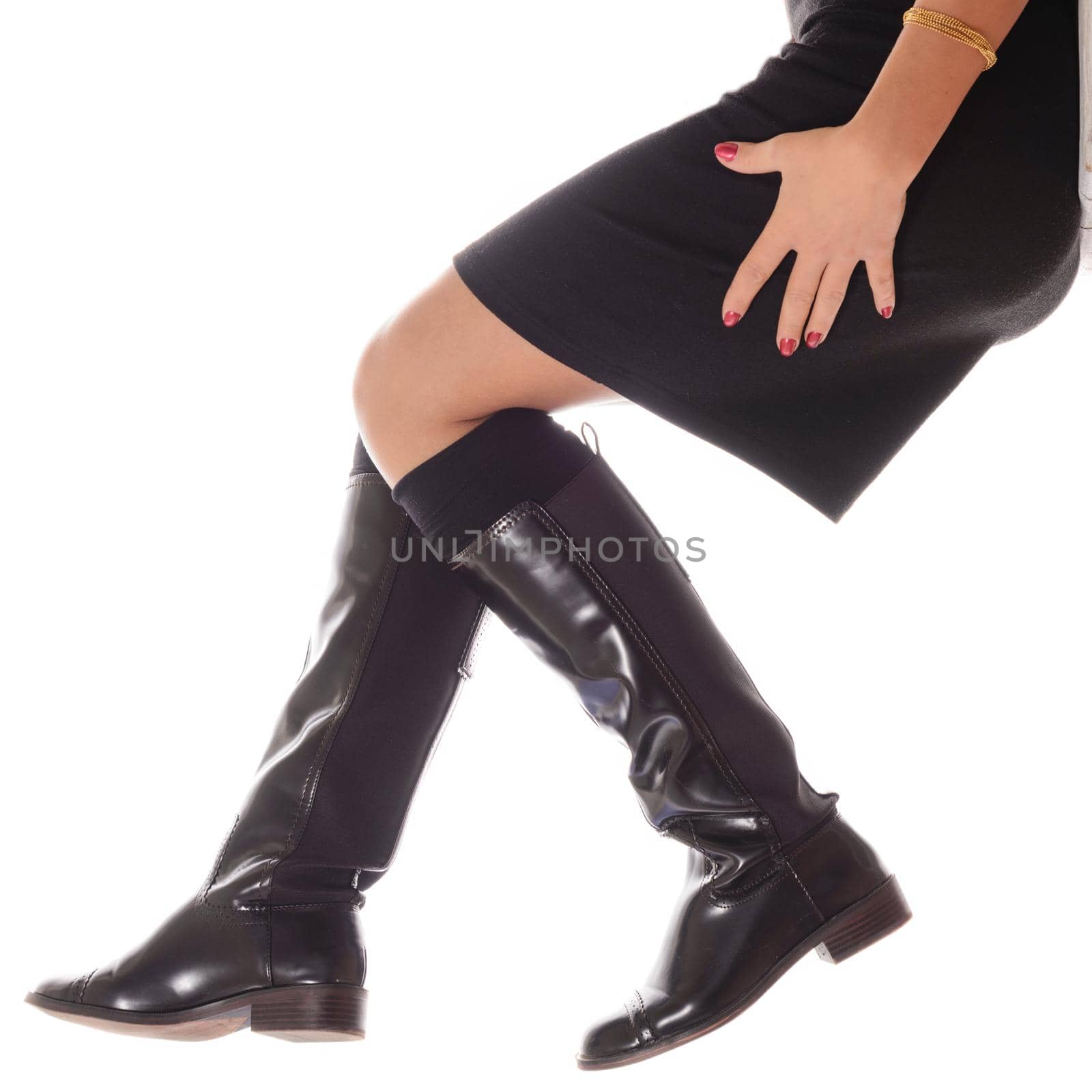 Female legs in high brown leather boots isolated on white