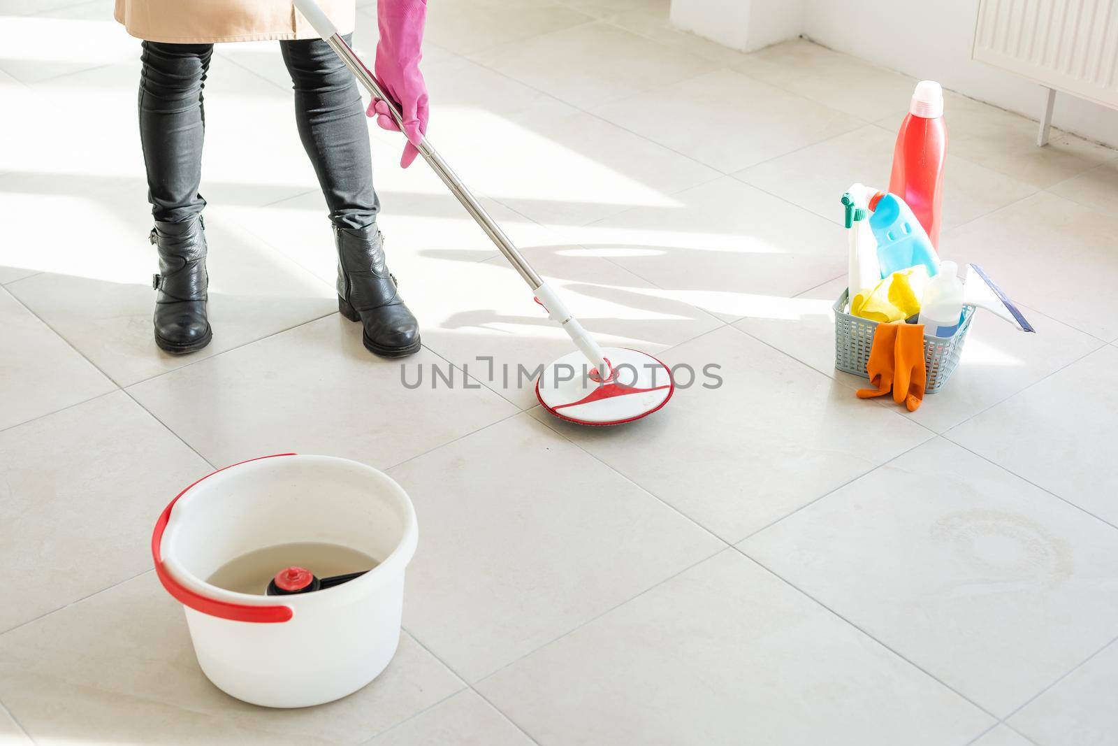 Spring cleaning woman cleaning floor with mop.