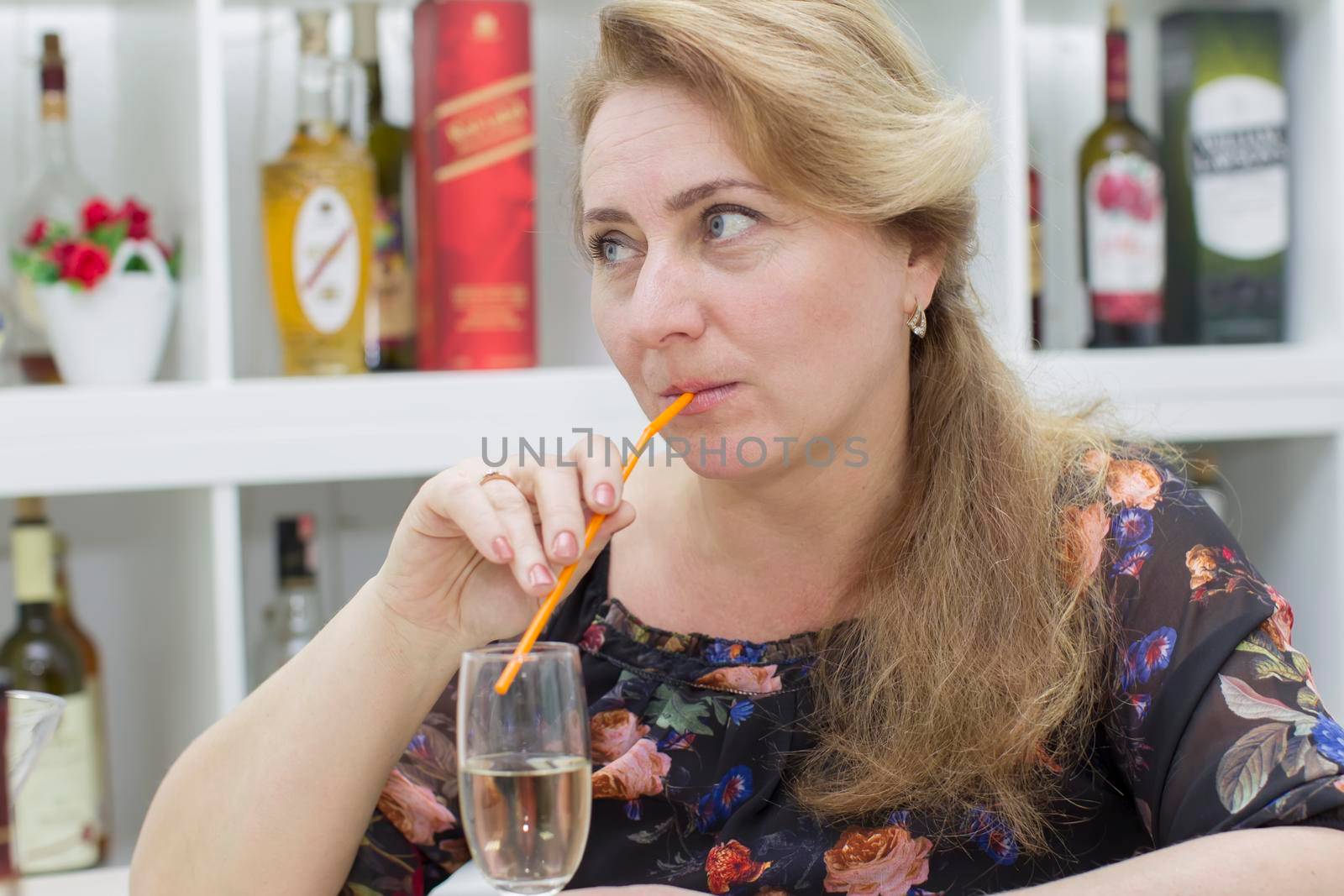 Woman drinking alcoholic cocktail from a straw