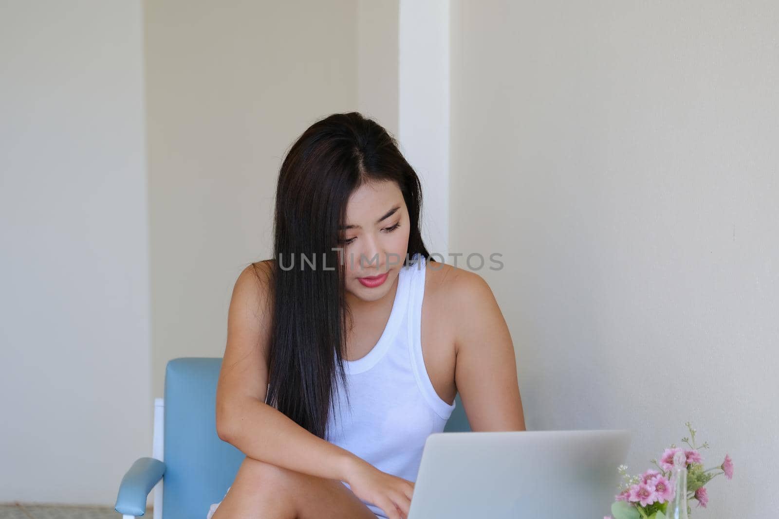 new normal, a businesswoman using computer to work for a company Via the internet on your desk at home.. by Manastrong