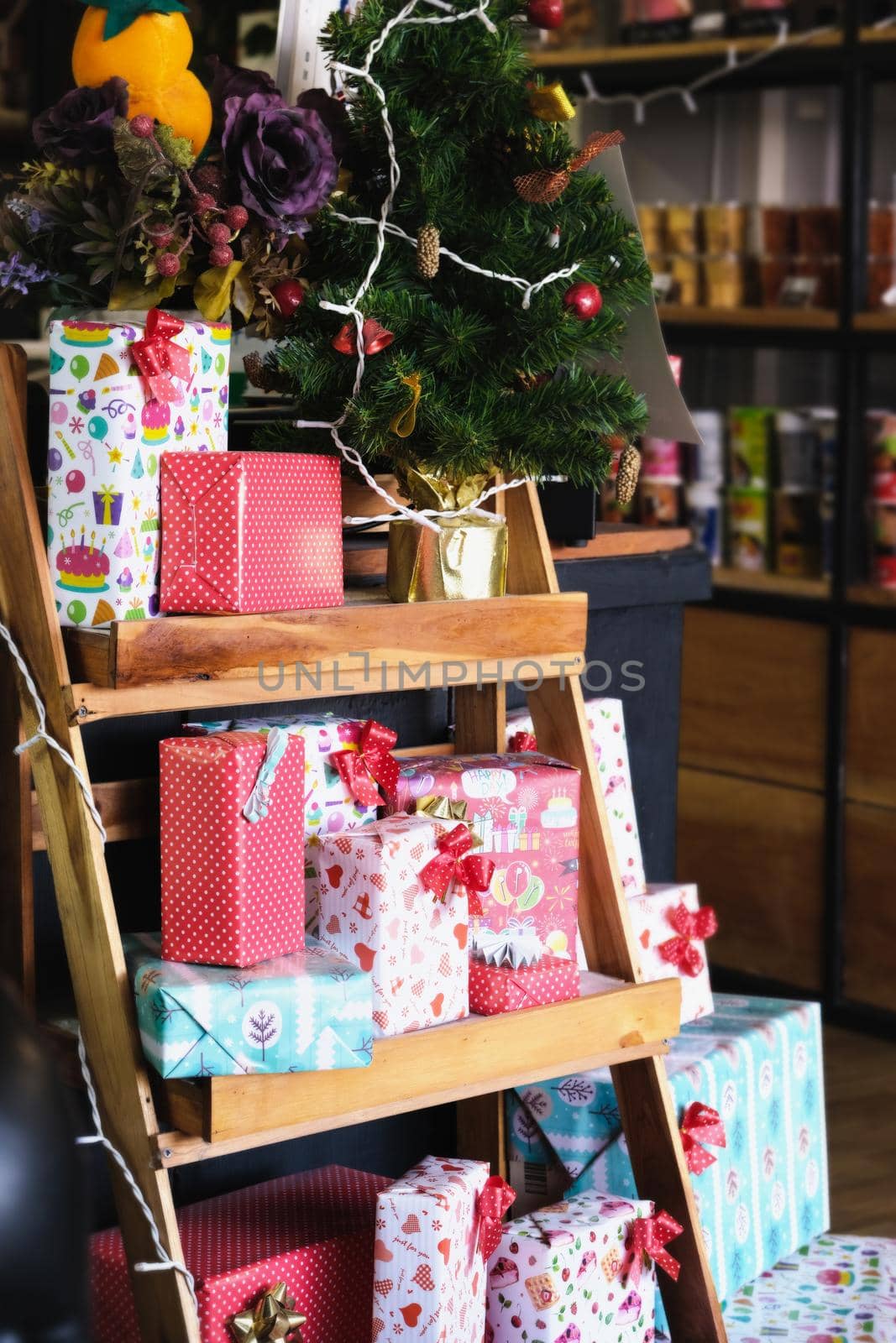 Lots of gift boxes put on a wooden shelf for Christmas. by Manastrong