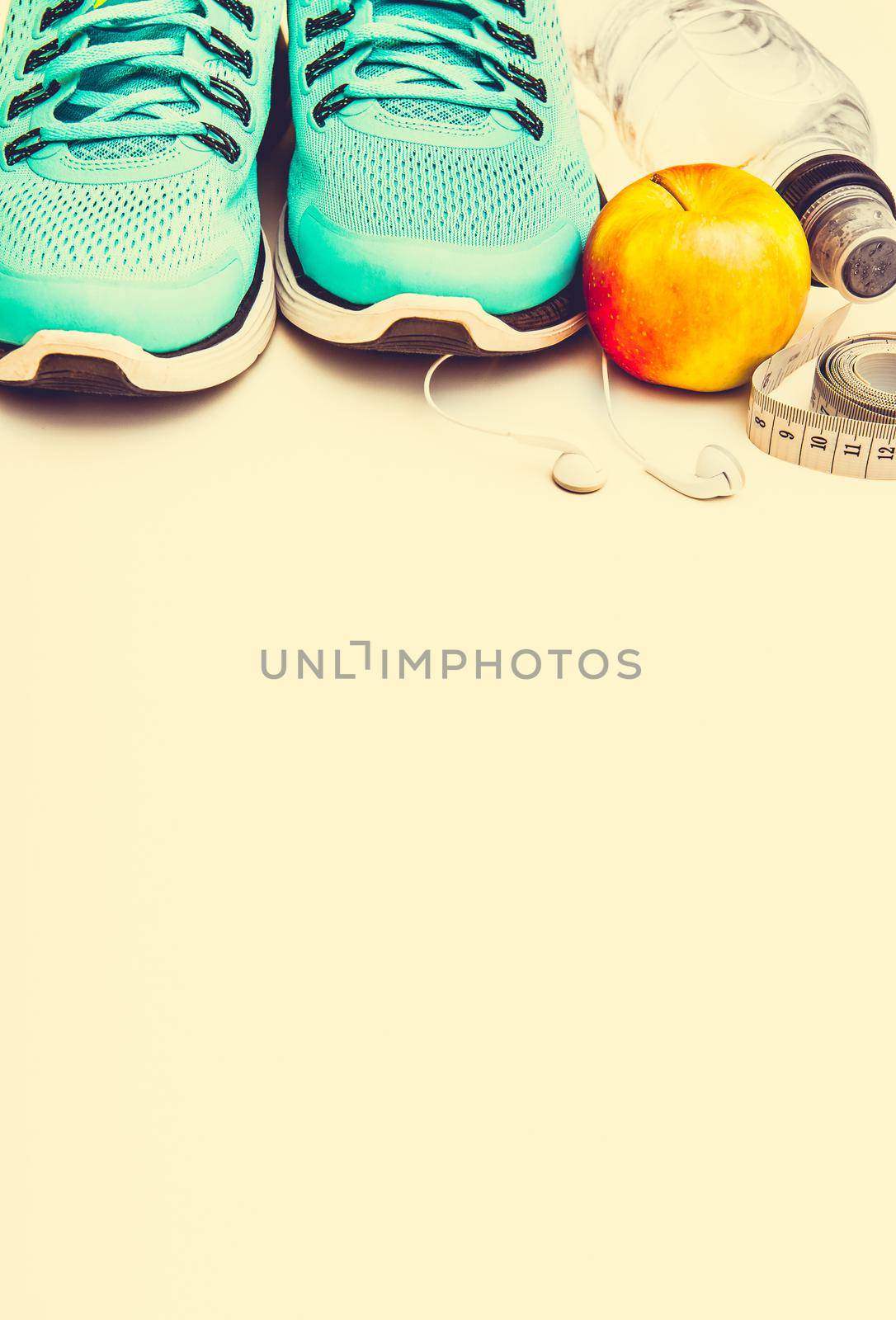 sport background: blue running shoes and apple with objects isolated on white background