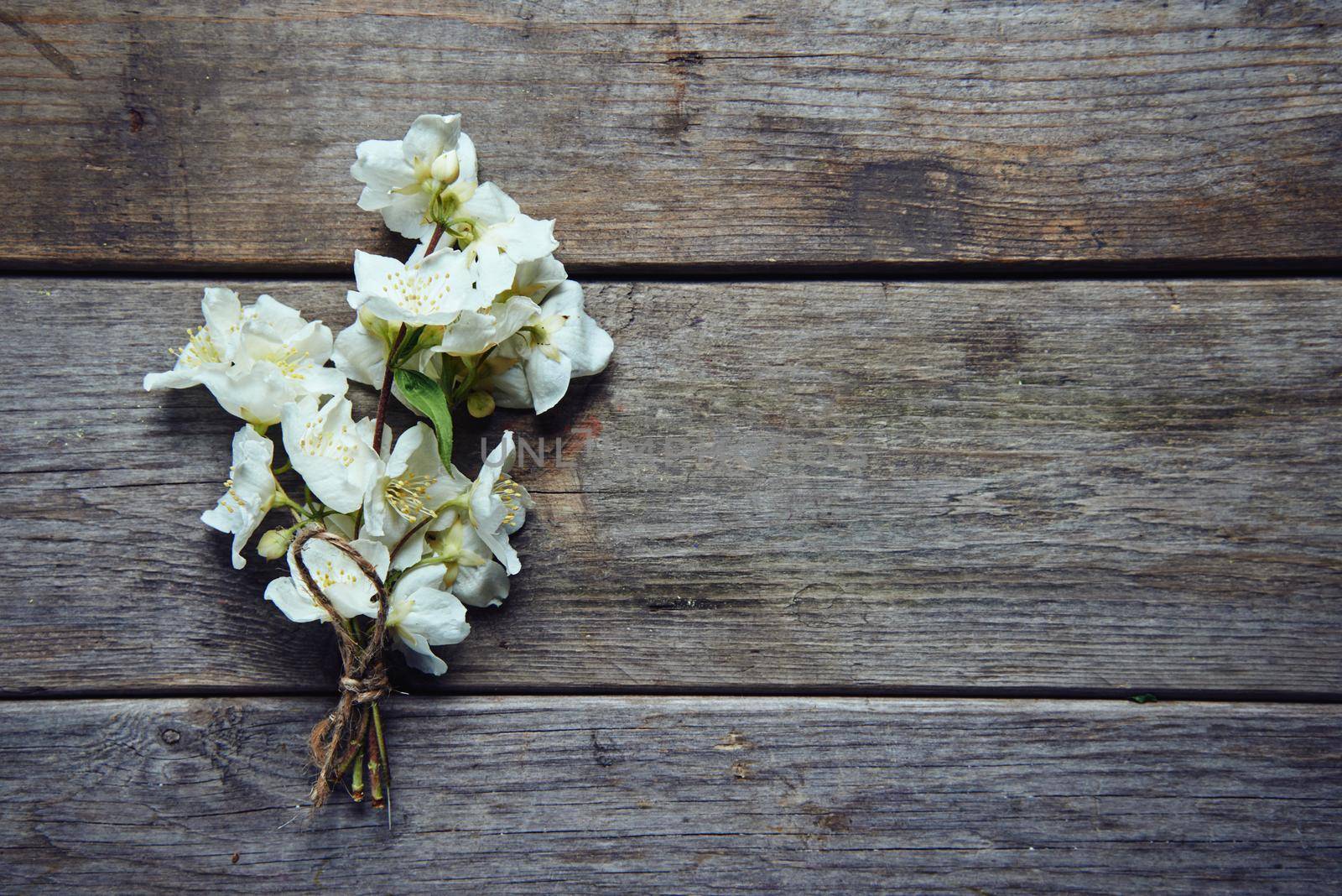 Bunch of jasmine flowers on wooden table