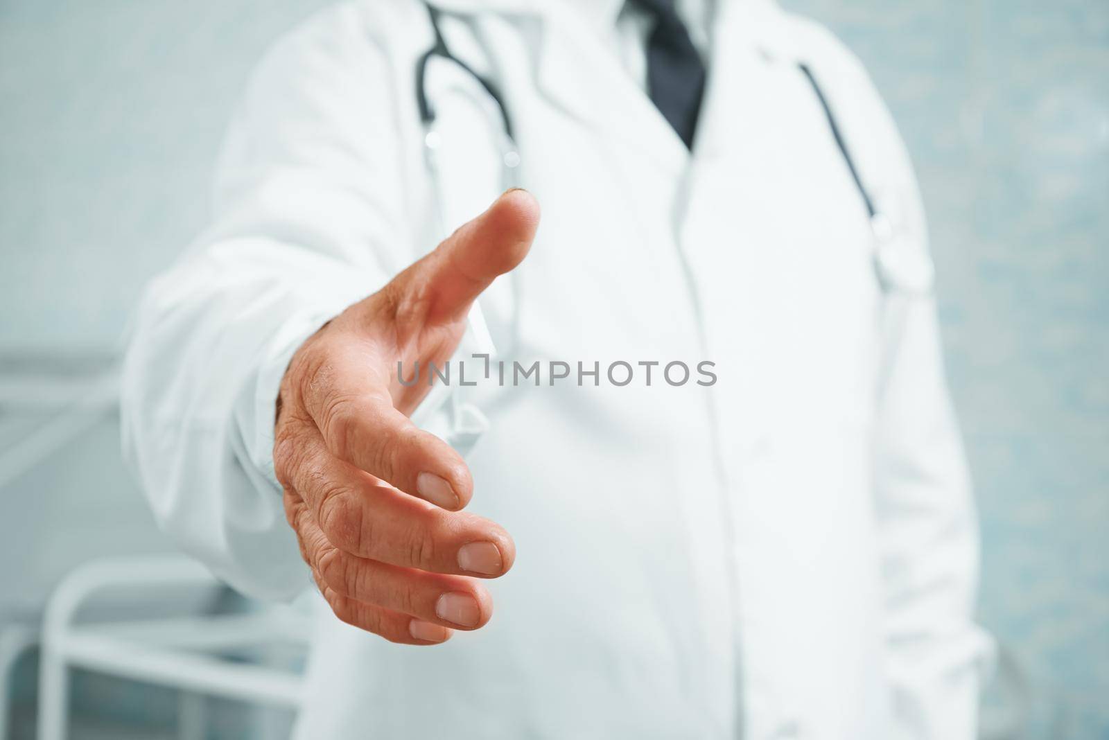 Unrecognizable older man doctor gives his hand for handshake