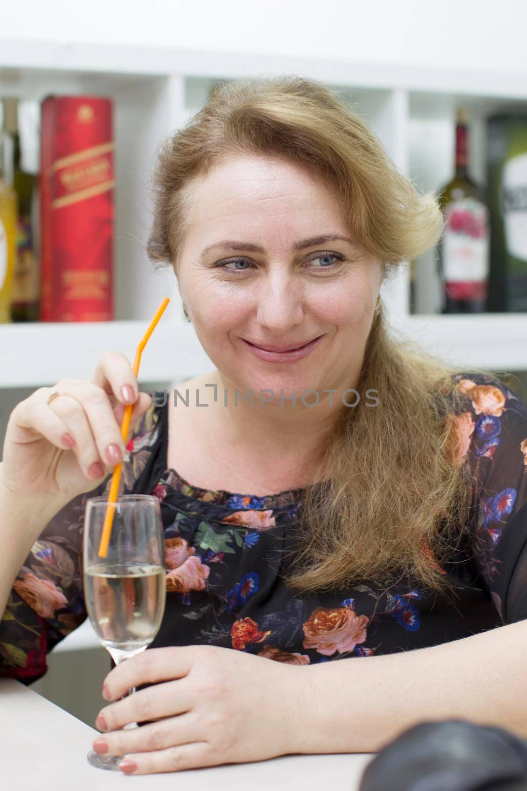 Woman drinking alcoholic cocktail from a straw