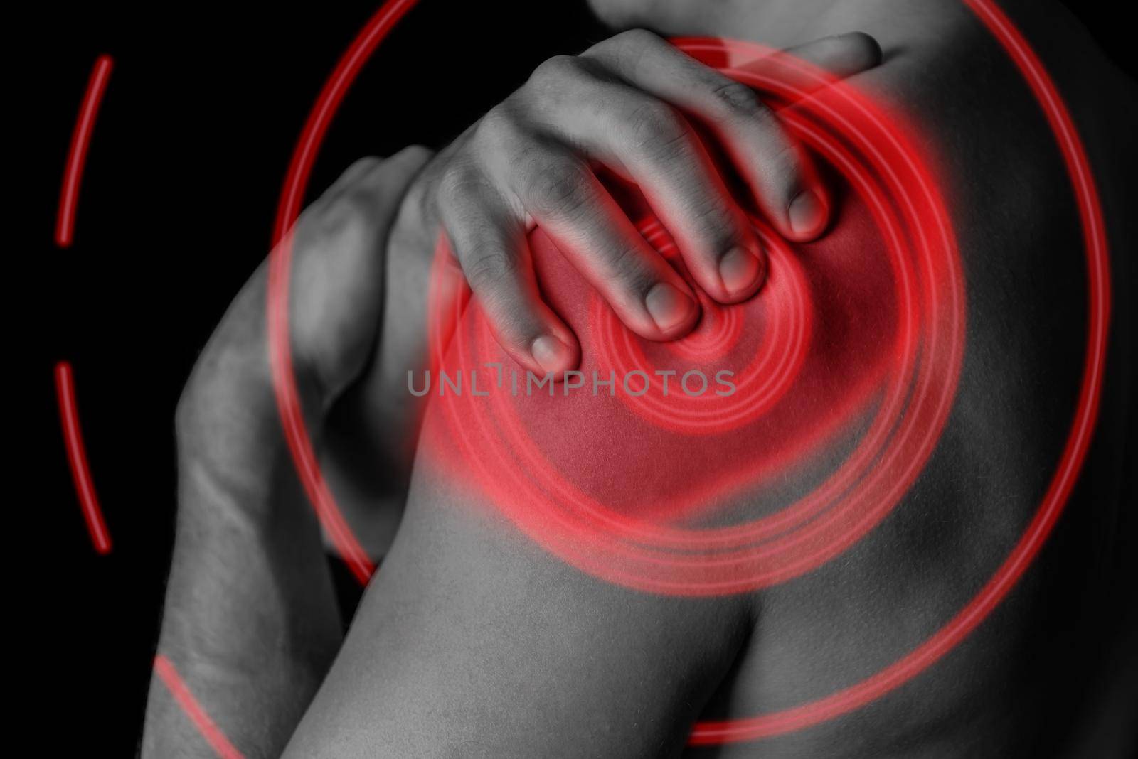 Man compresses his shoulder, pain in the shoulder, black and white image, pain area of red color