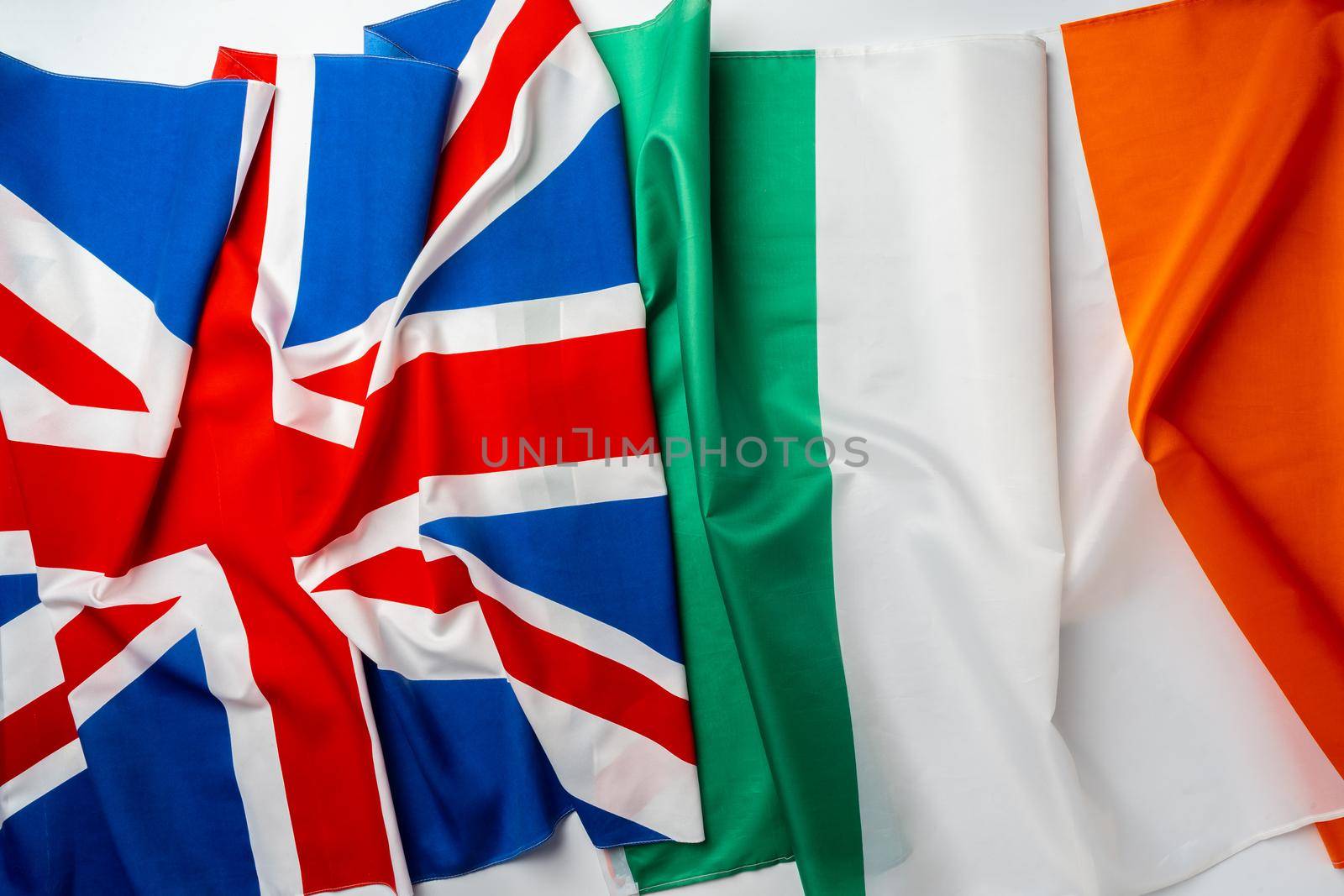 Flags of UK and Ireland folded together close up
