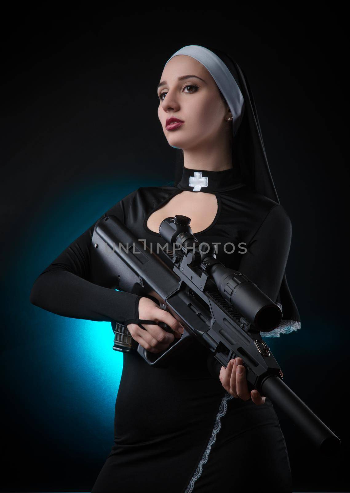 girl on a black background in a nun dress posing with a gun, aiming, shooting