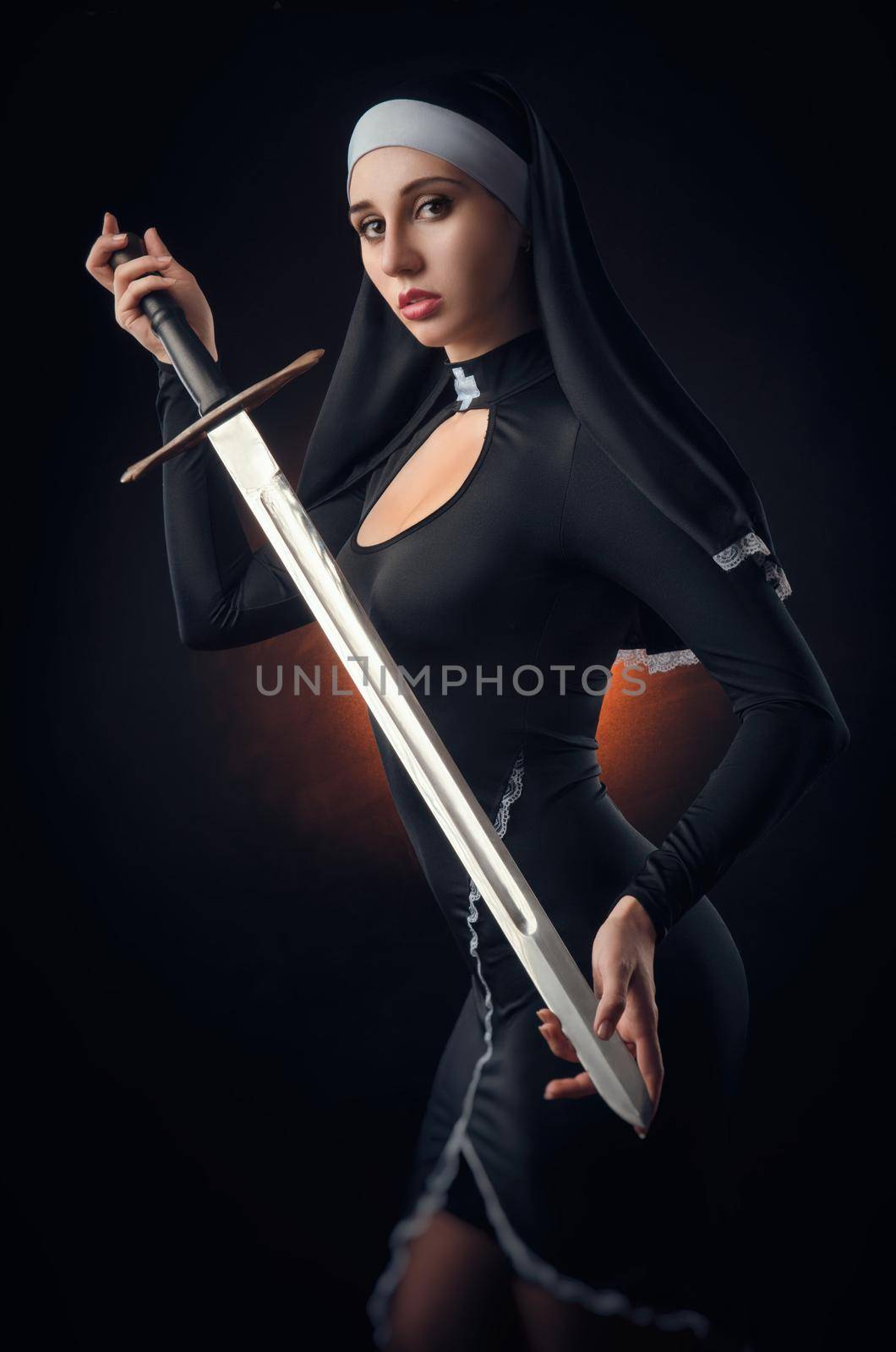 girl on a black background in a nun dress posing with a gun, aiming, shooting