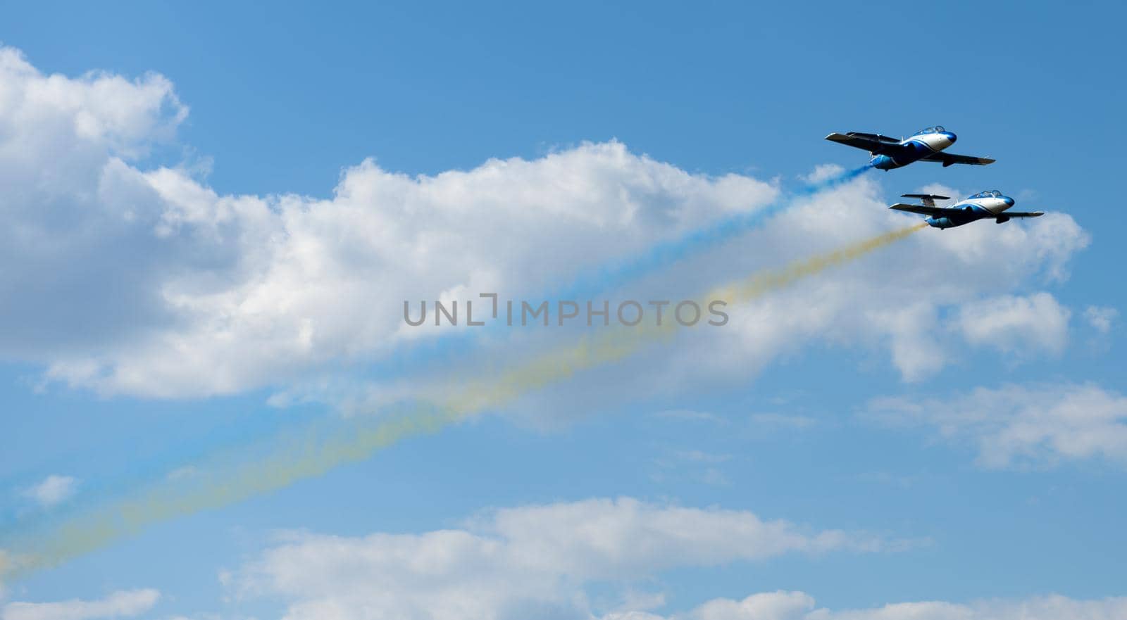 Kharkiv, Ukraine - August 24, 2015: planes performing colorful trails at Kharkiv airshow