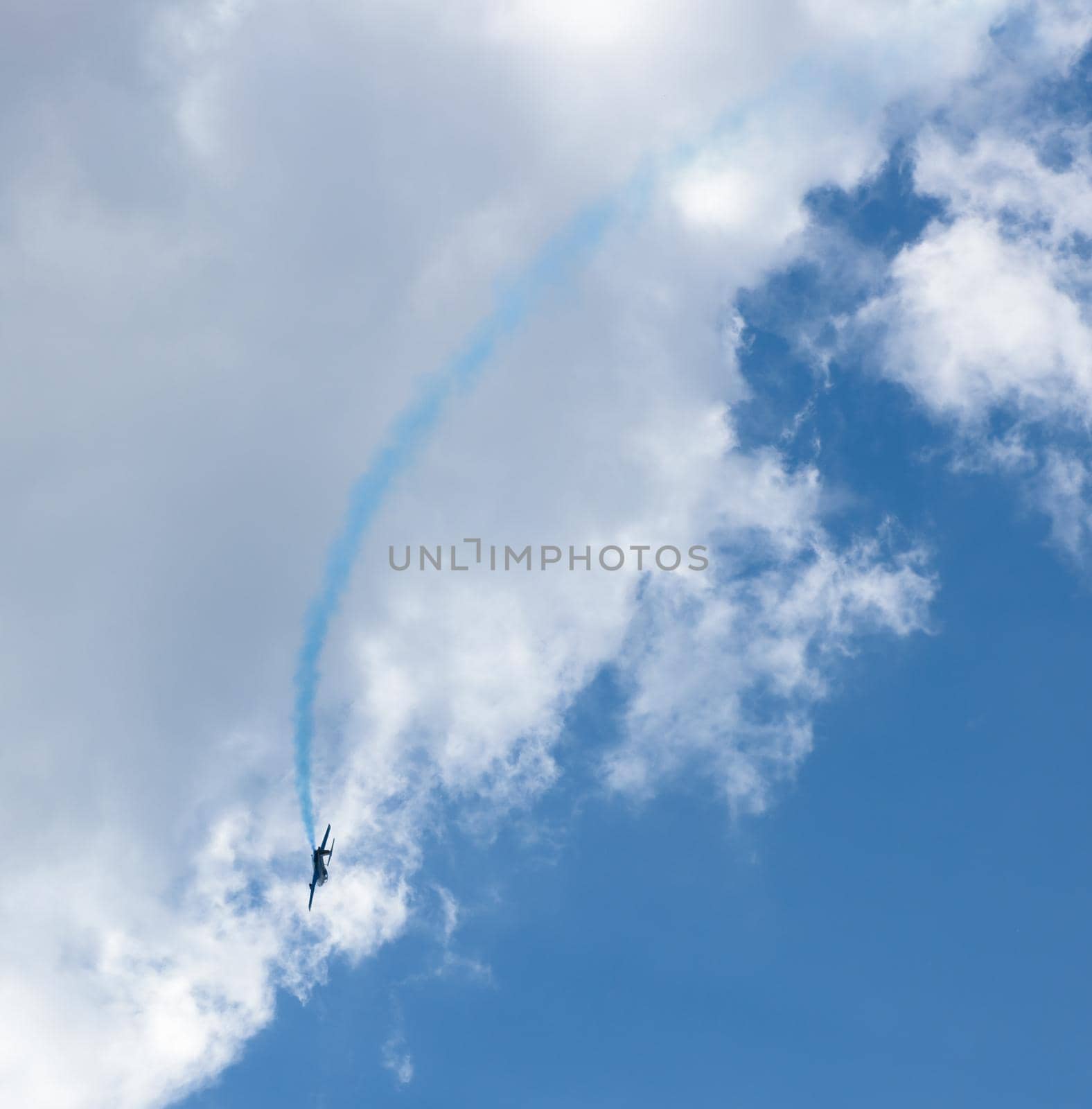 Kharkiv, Ukraine - August 24, 2015: plane with colorful trail in the sky at Kharkiv airshow