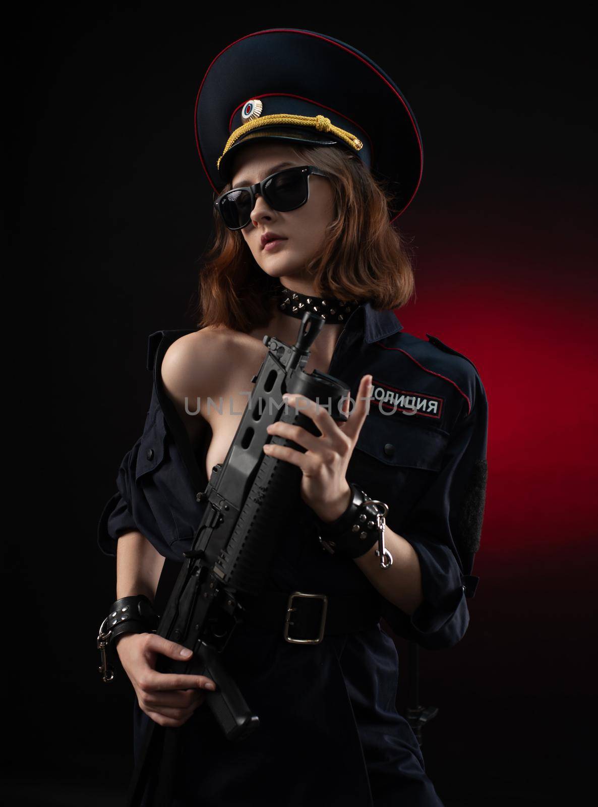 the naked girl in a police uniform with a gun . English translation of the police