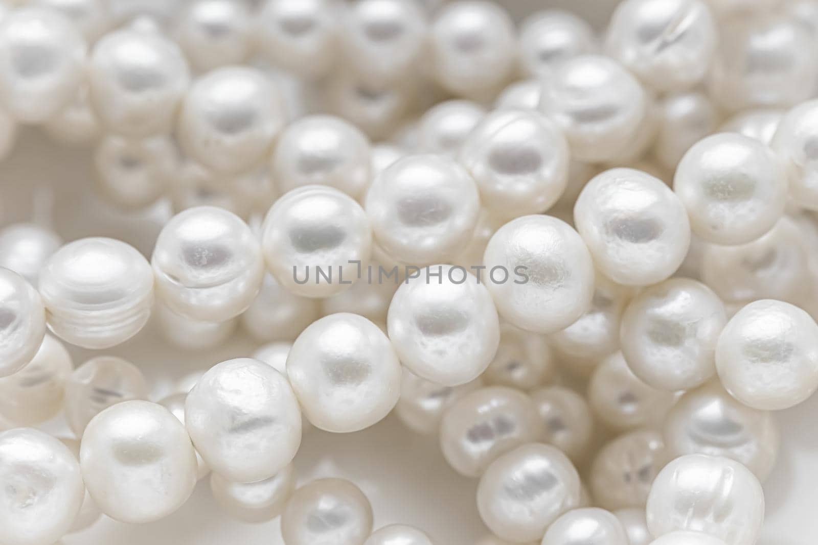 Nature white string of pearls in soft focus, with highlights by Olayola