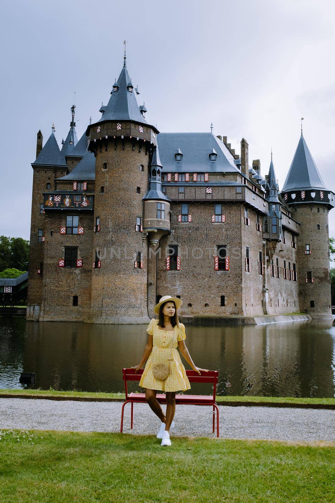 Castle de Haar Utrecht, couple men and woman mid age Asian visit De Haar Castle in Dutch Kasteel de Haar is located in Utrecht Netherlands during Spring with flowers in the garden