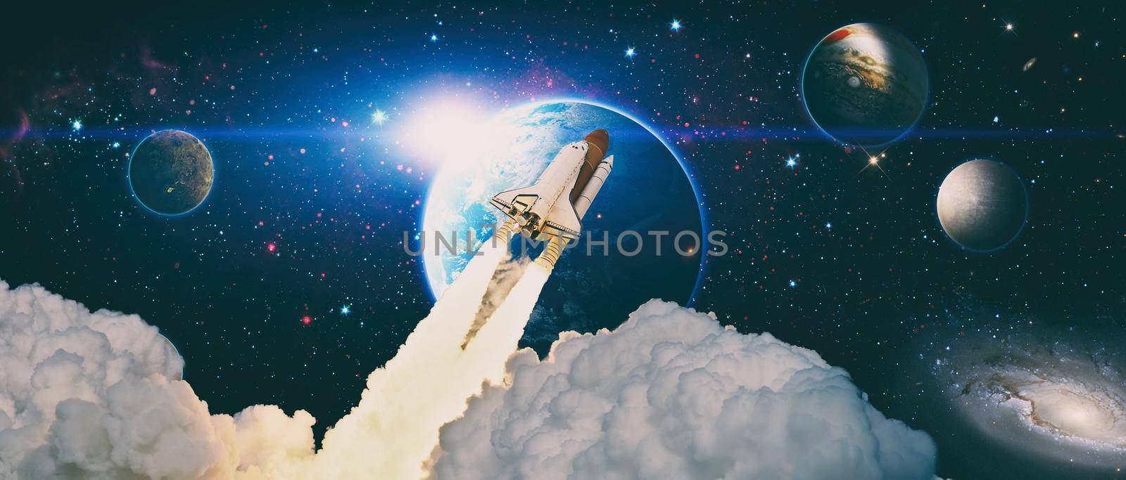 Space shuttle orbiting Earth planet.Rockets launch into space on the starry sky.  Elements of this image furnished by NASA by Maximusnd