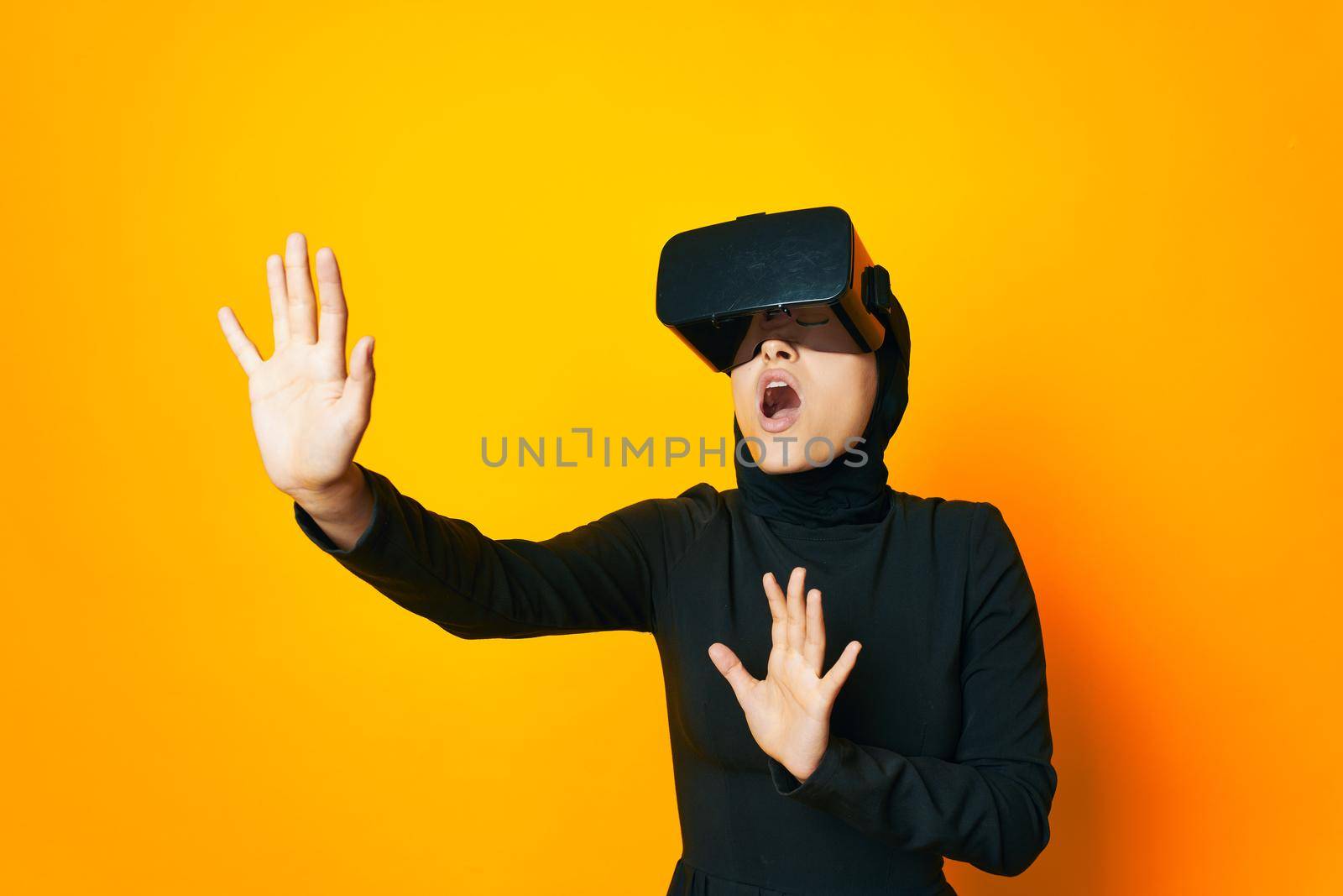 Muslim virtual reality glasses entertainment yellow background. High quality photo
