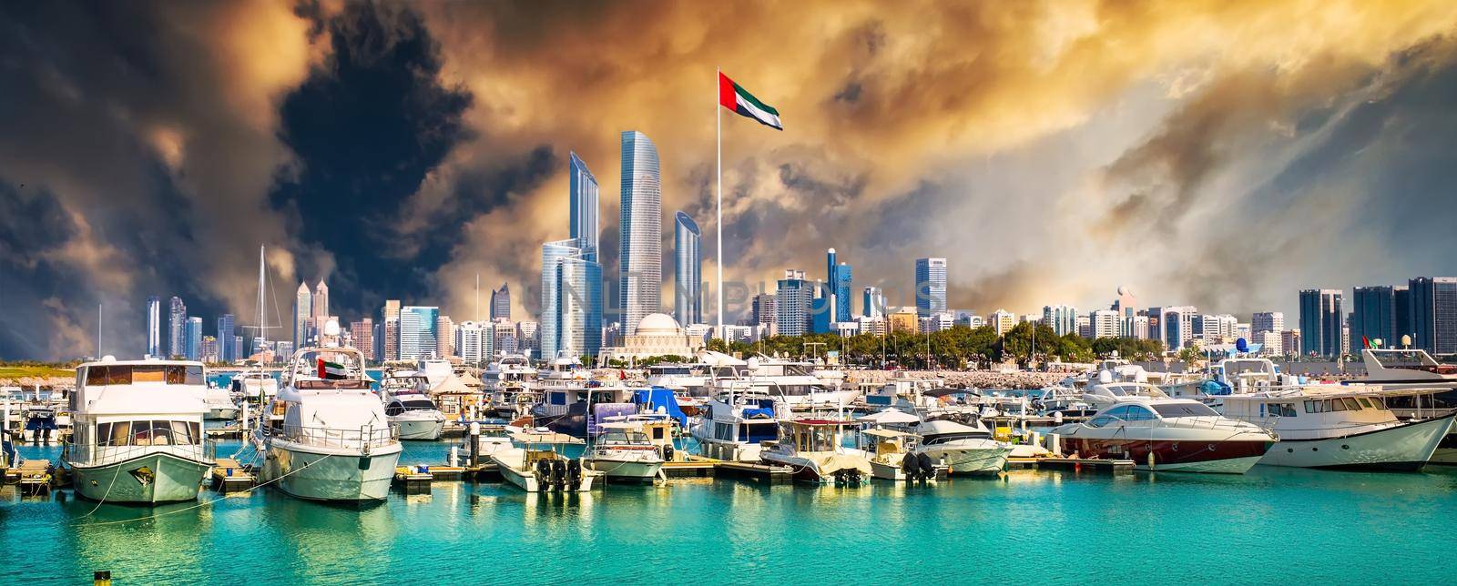 quay with yachts and skyscrapers at sunset in Abu Dhab