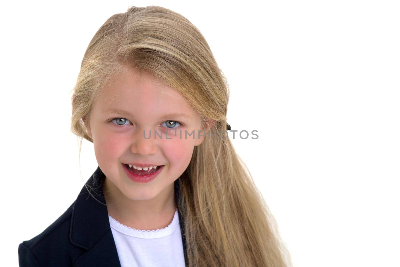 Front view portrait of beautiful little schoolgirl. Adorable blonde long haired girl posing against white background. Cute elementary school student in blue jacket and white blouse