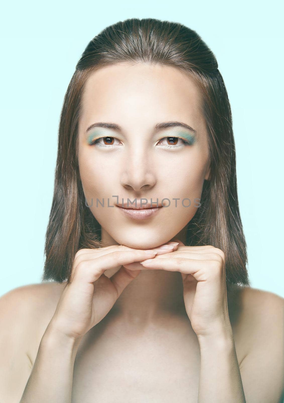 Portrait of young beautiful brunette woman with bright make-up