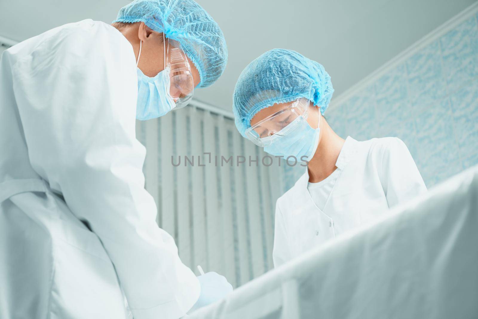 Two surgeons in operating room by alexAleksei
