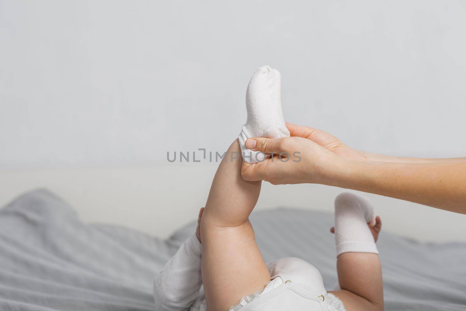 baby putting socks by Zahard