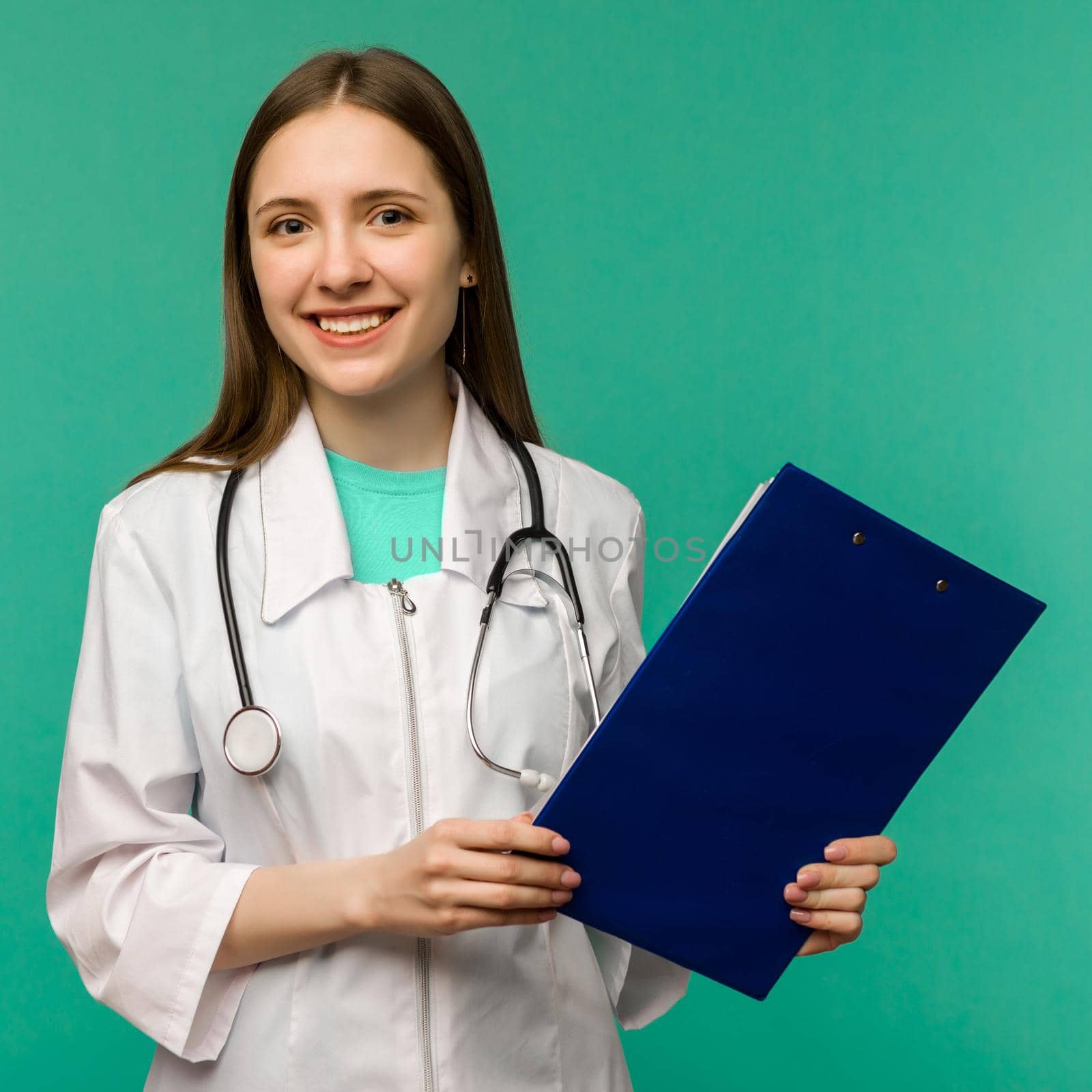 Happy smiling female doctor with clipboard, isolated over background by zartarn