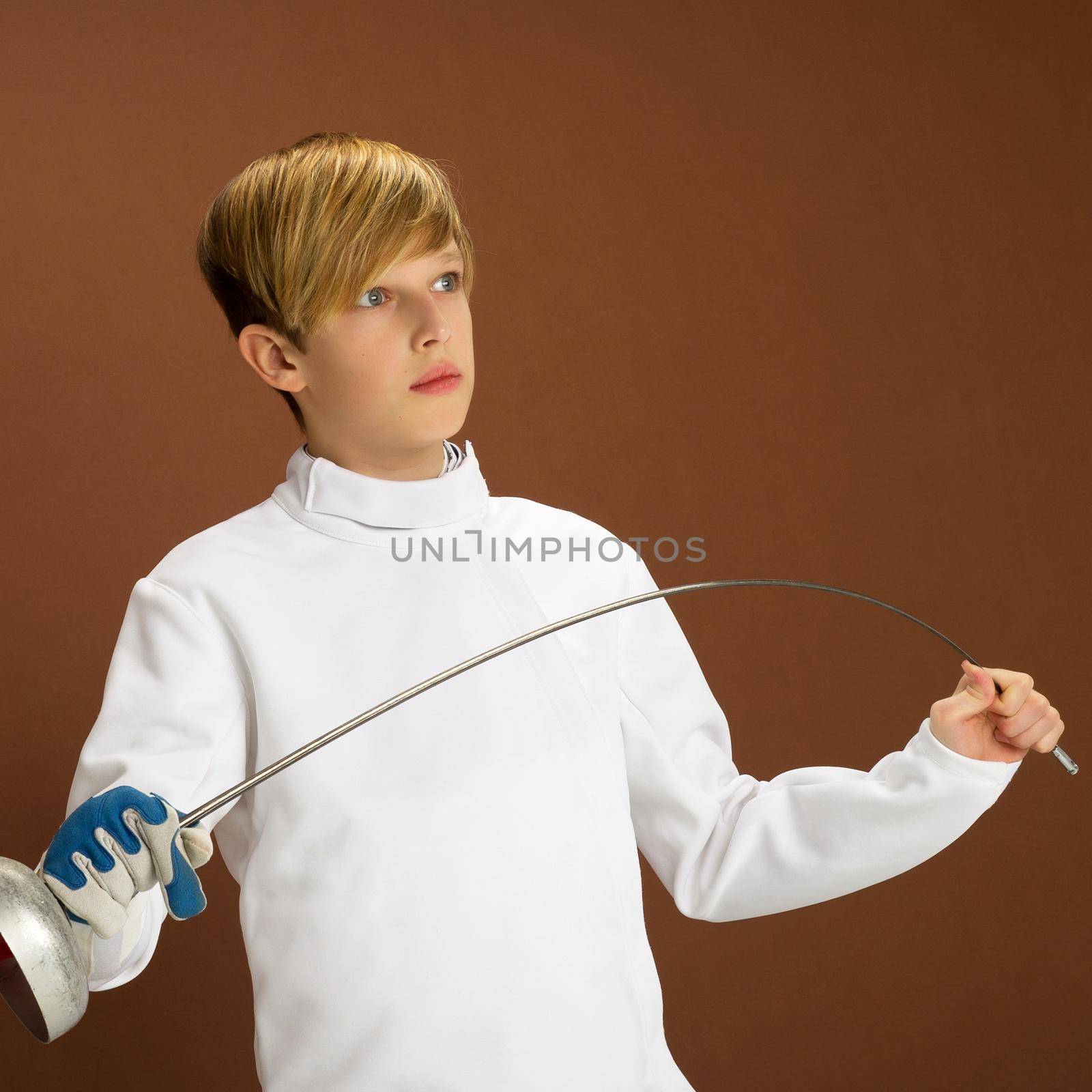 Boy fencer in white fencing costume with rapier by kolesnikov_studio