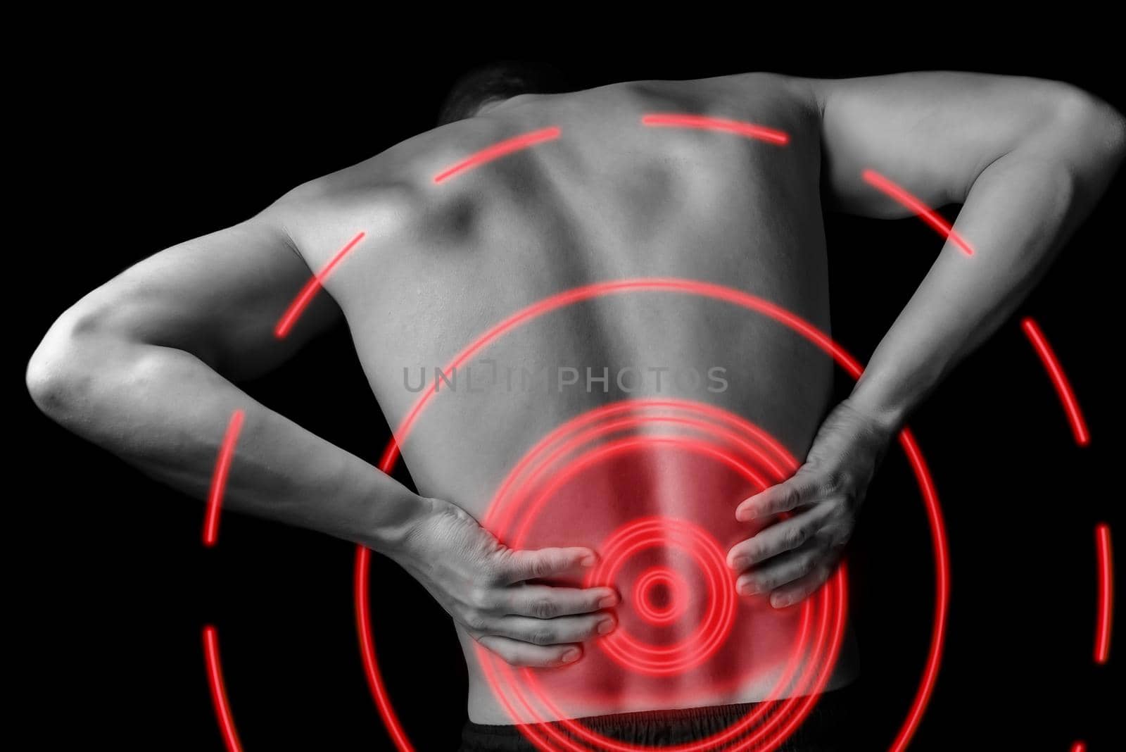 Acute pain in a male lower back, monochrome image, pain area of red color