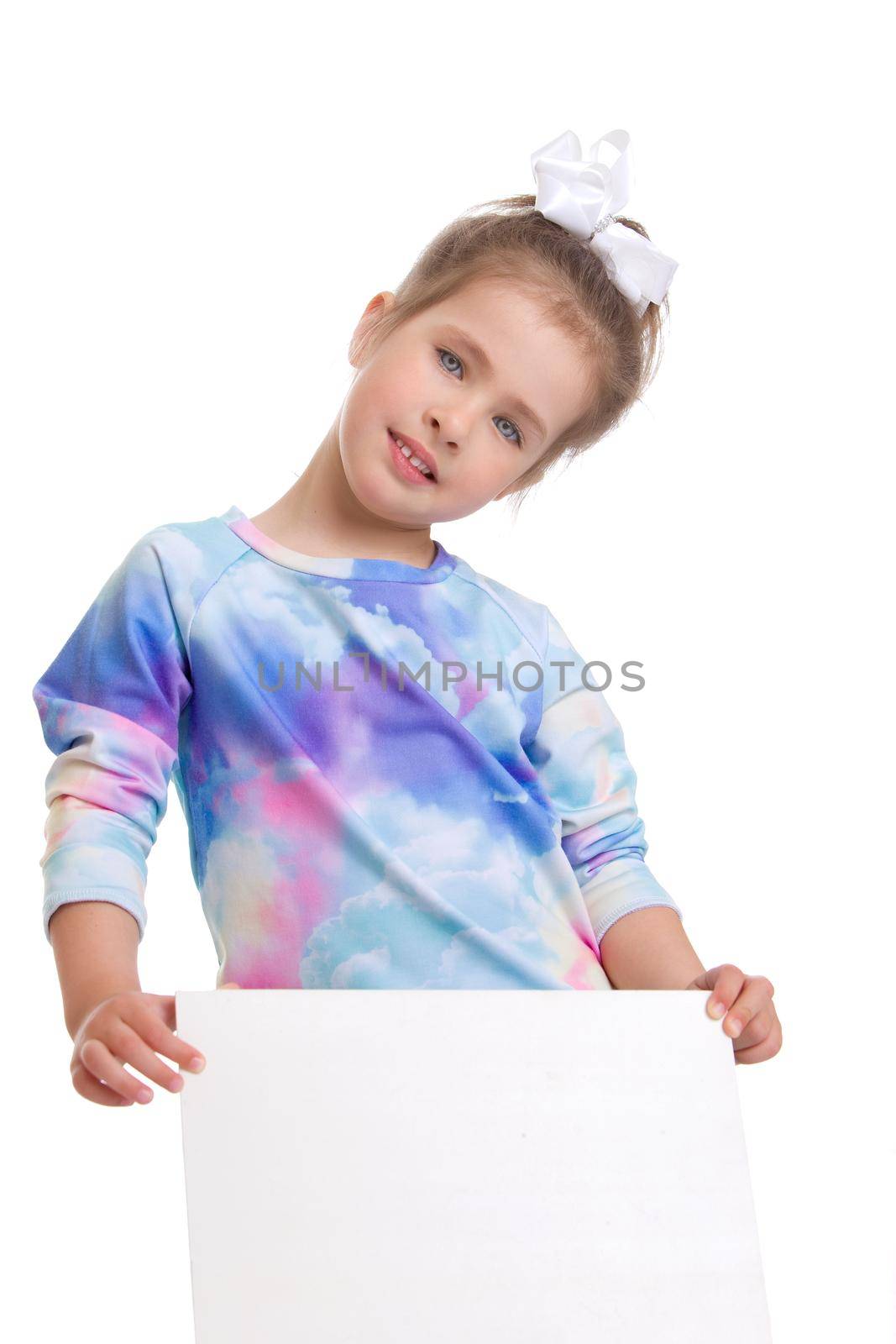 Portrait of beautiful preteen girl. Lovely girl in bright summer dress posing on isolated white background. Close up shot of child looking at camera with serious face expression