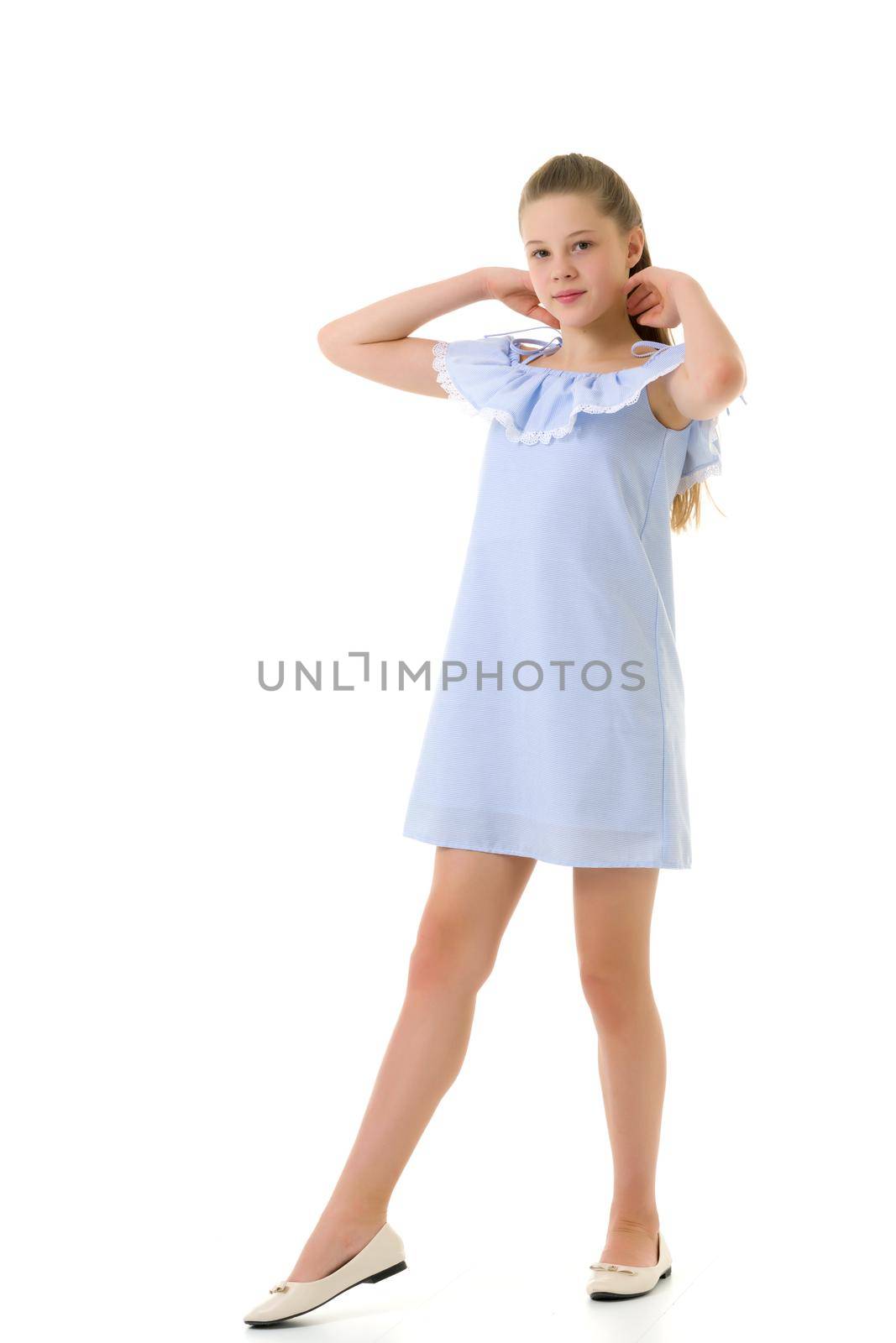 Teen Girl Standing with Raising Hands and Looking at Camera, Portrait of Beautiful Girl in Light Sundress and Beige Shoes, Pretty Teenager in Stylish Clothes Posing in Studio Against White Background