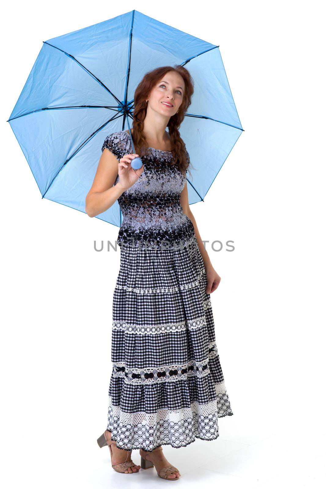 Beautiful woman walking under umbrella. Young woman wearing long elegant summer dress posing on isolated white background. Full length portrait of cheerful girl smiling at camera