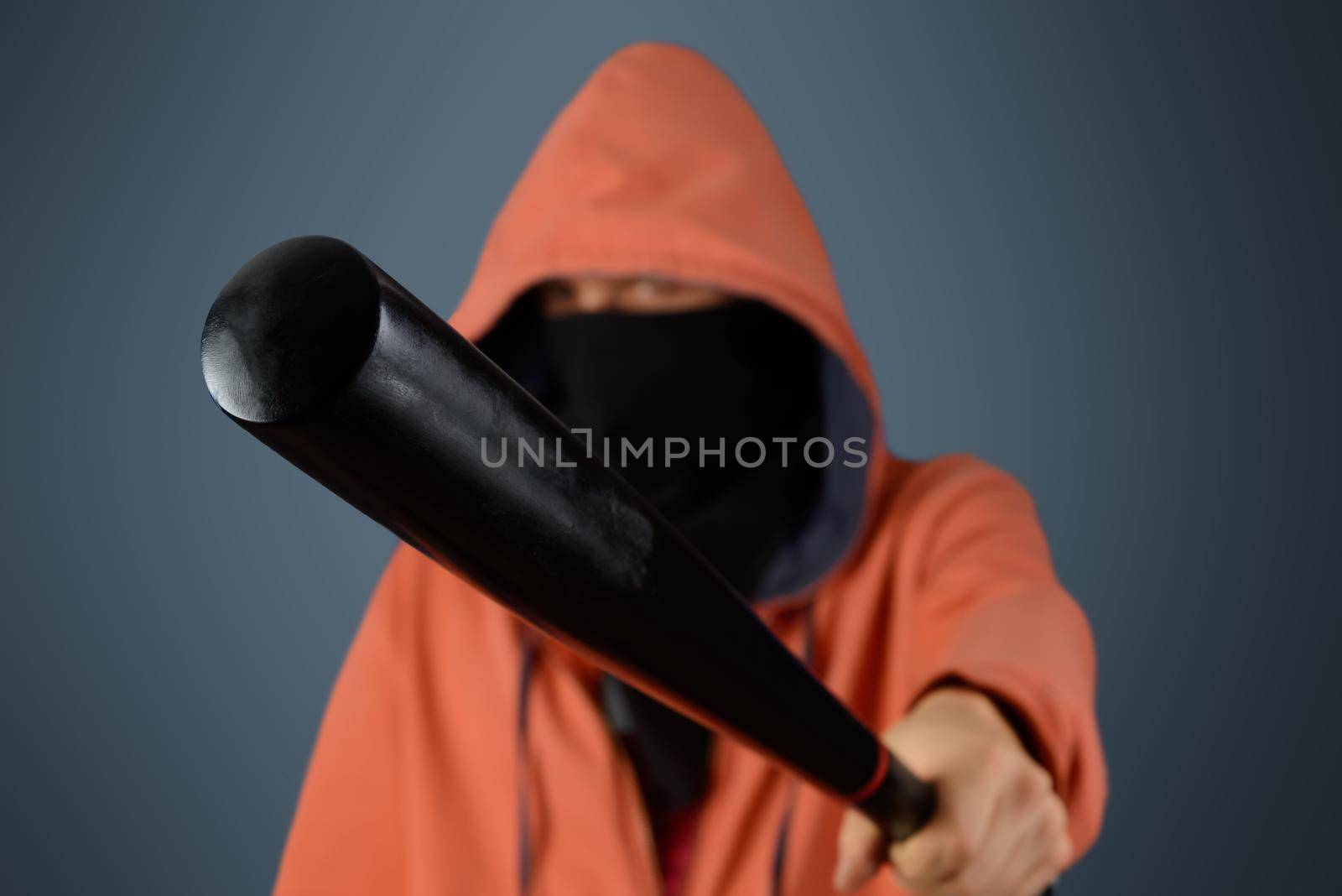 Aggressive man in mask holds baseball bat