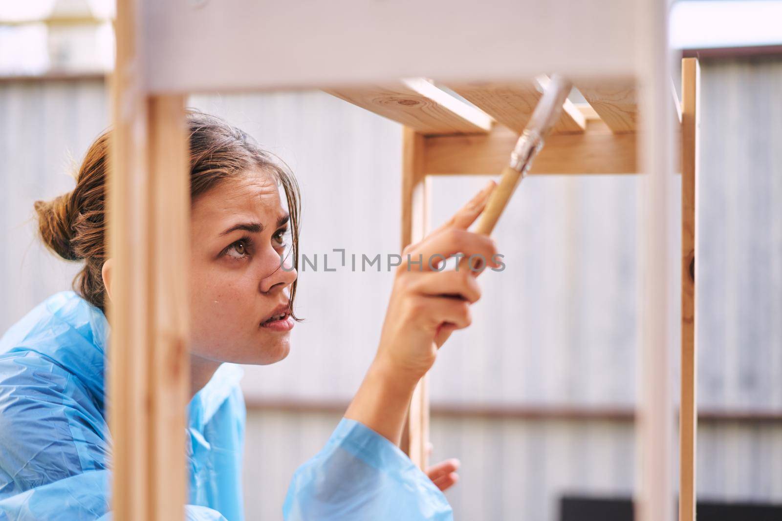 cheerful woman house painter in protective suit repairing home. High quality photo