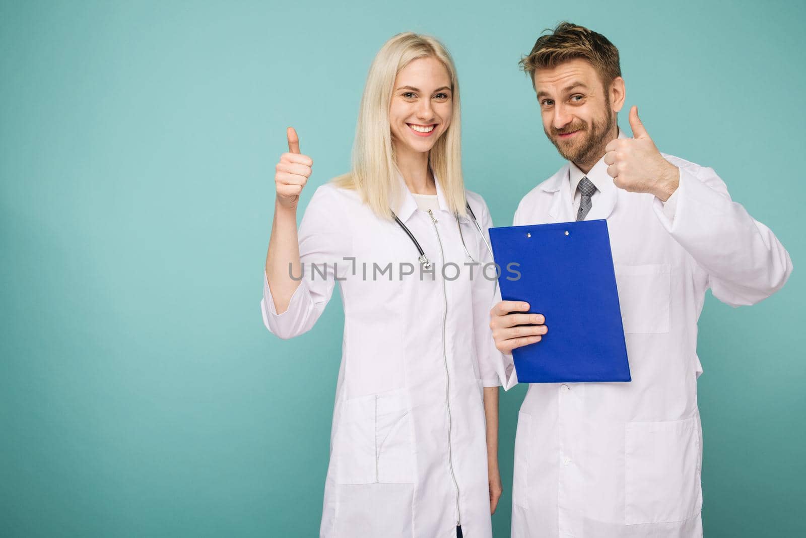 Friendly Male and Female Doctors. Happy medical team of doctors. Thumb up- Image