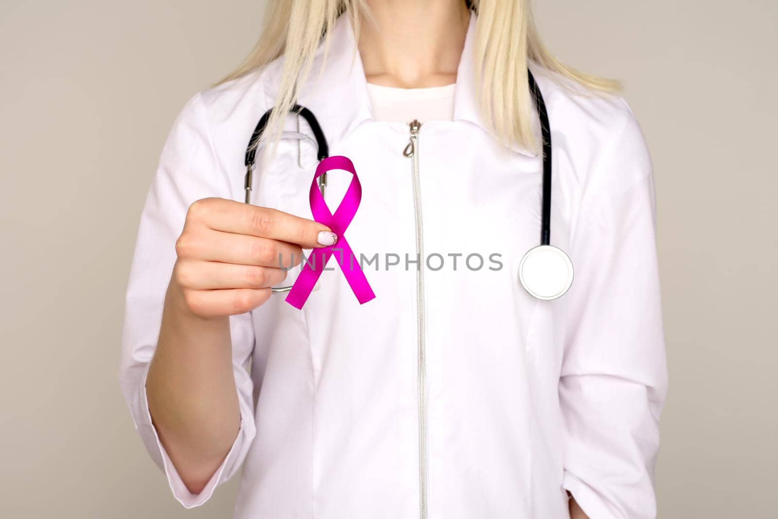 Female Doctor Holds Pink Ribbon, International Breast Cancer Day October 7 - Image